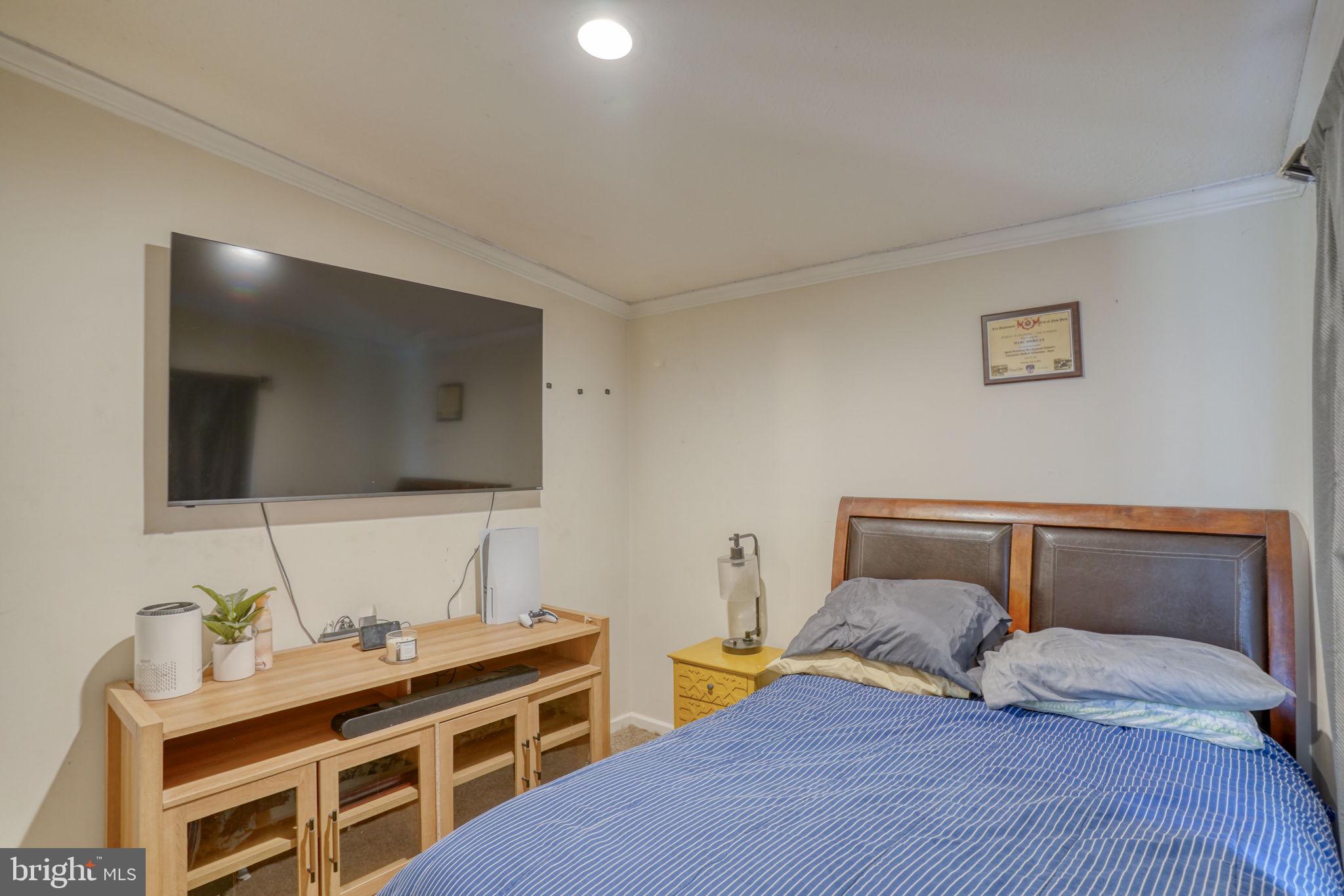413 4th Street Frederica, DE 19946 - Photo 25 of 31 a bedroom with a bed and a flat screen tv