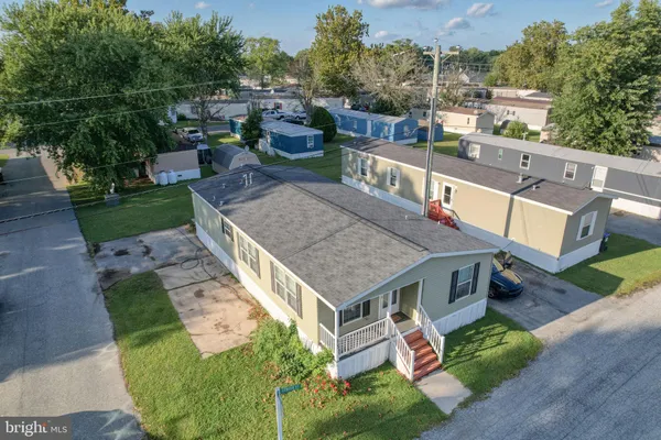 an aerial view of a house with swimming pool garden and patio