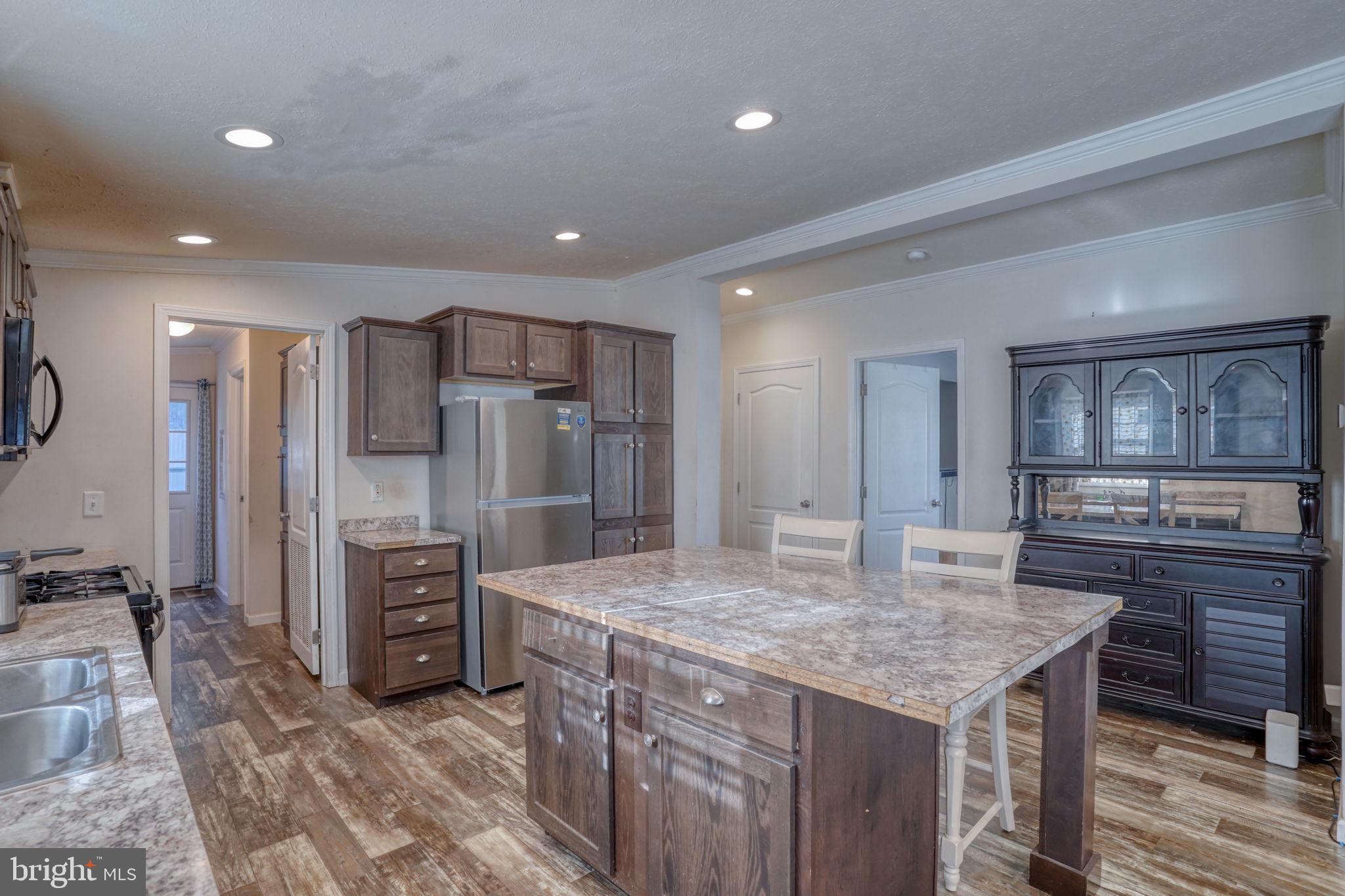 413 4th Street Frederica, DE 19946 - Photo 5 of 31 a kitchen with stainless steel appliances granite countertop a sink refrigerator and cabinets