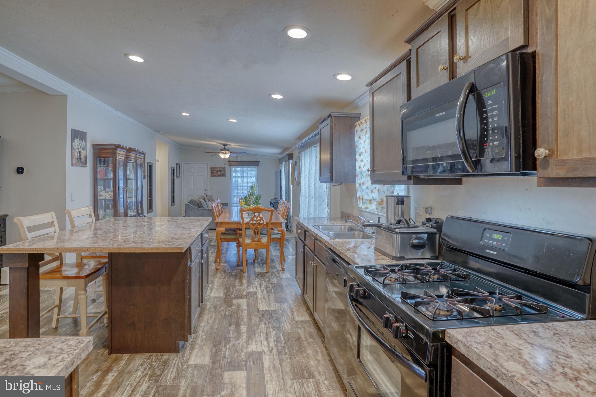 413 4th Street Frederica, DE 19946 - Photo 7 of 31 a kitchen with stainless steel appliances granite countertop a stove and a sink