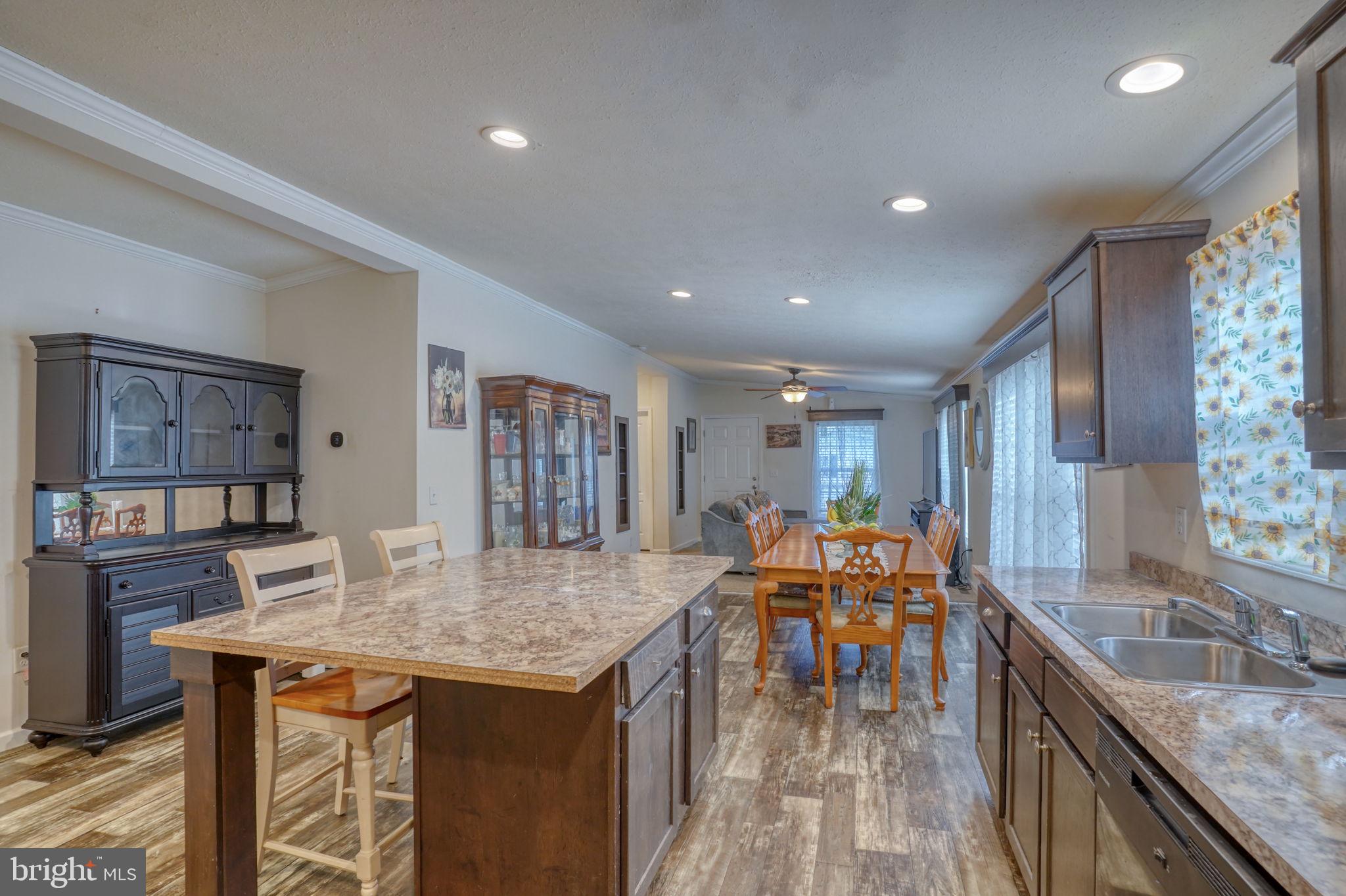 413 4th Street Frederica, DE 19946 - Photo 8 of 31 a kitchen with stainless steel appliances granite countertop table chairs and wooden floor
