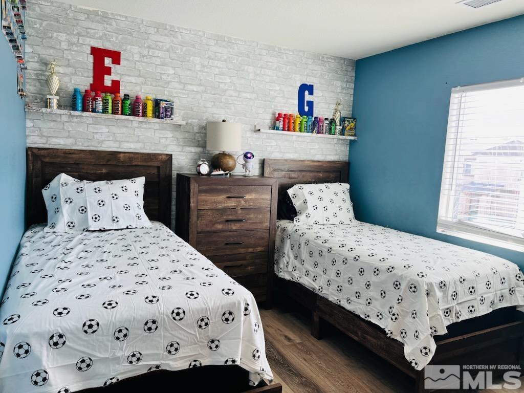8908 Quail Falls Drive Reno, NV 89506 - Photo 13 of 17 a bedroom with a bed a dresser and a book shelf
