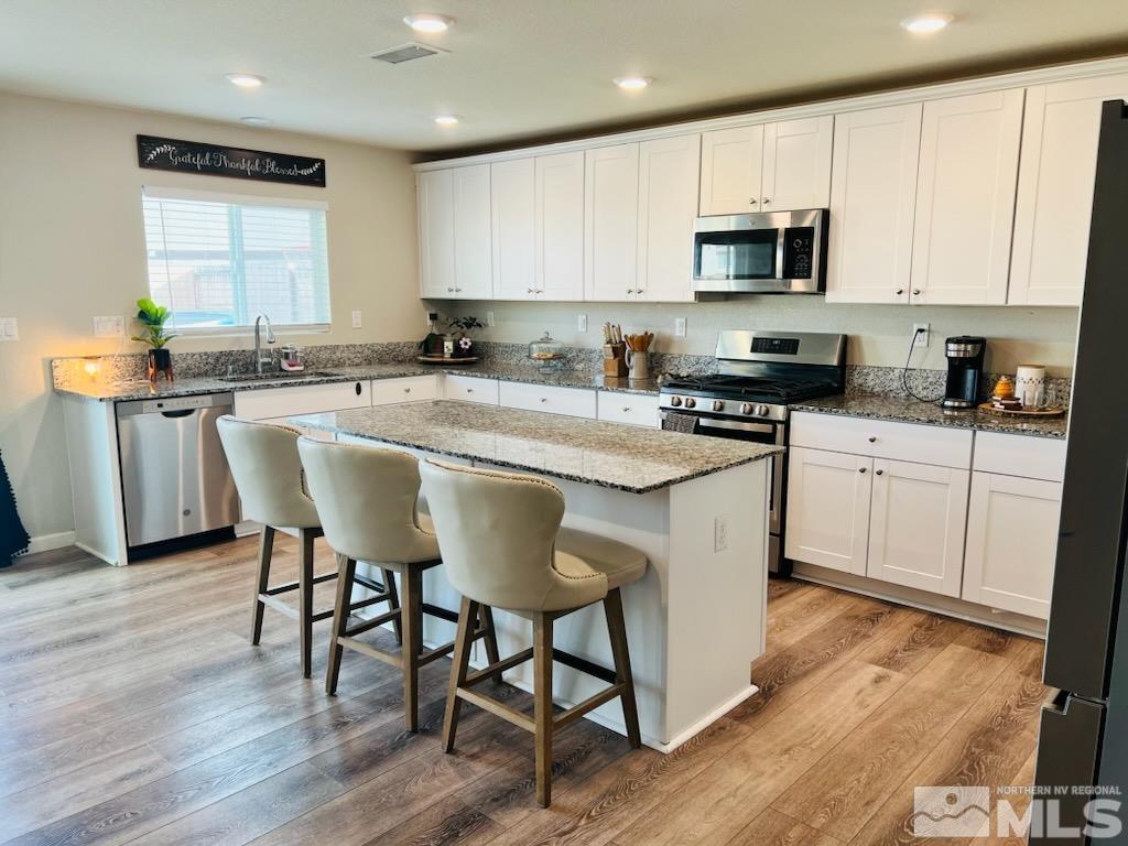 8908 Quail Falls Drive Reno, NV 89506 - Photo 5 of 17 a kitchen with a sink a microwave and cabinets