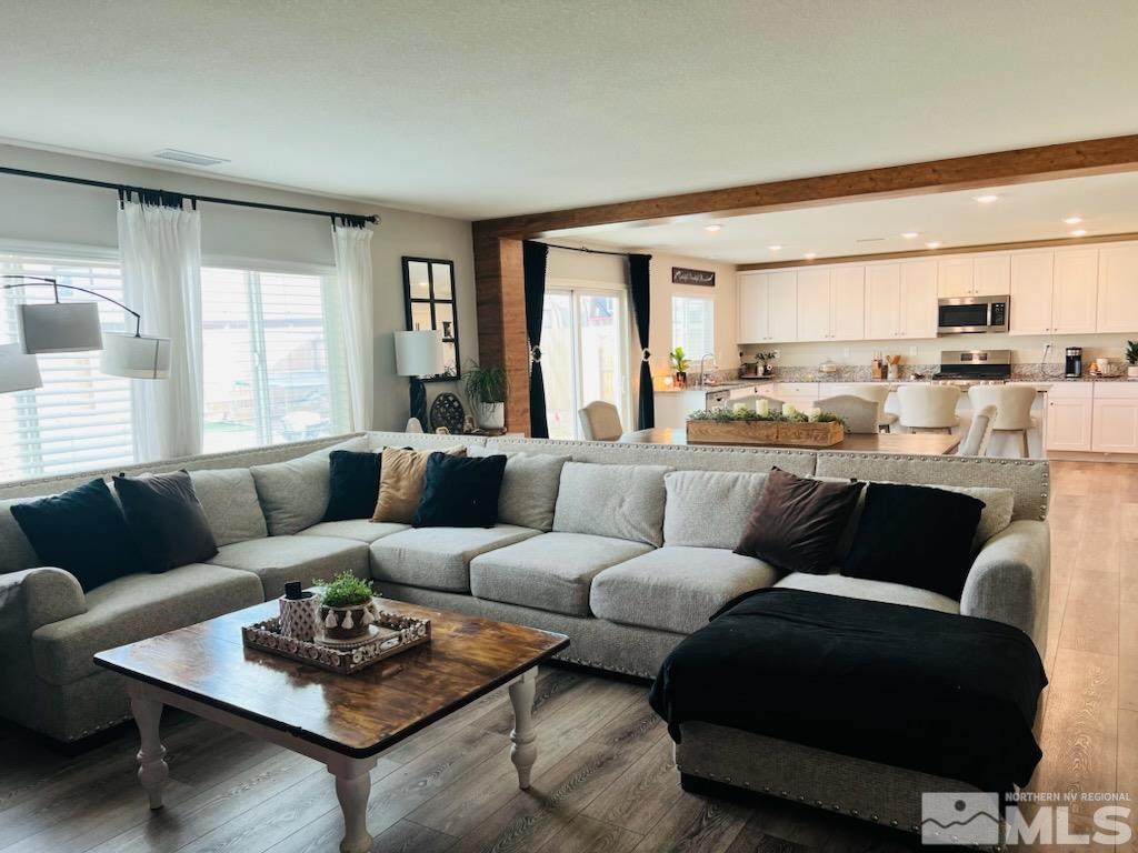 8908 Quail Falls Drive Reno, NV 89506 - Photo 6 of 17 a living room with furniture kitchen view and large windows
