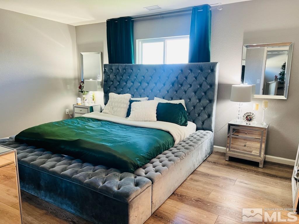 8908 Quail Falls Drive Reno, NV 89506 - Photo 8 of 17 a bedroom with a bed and a couch