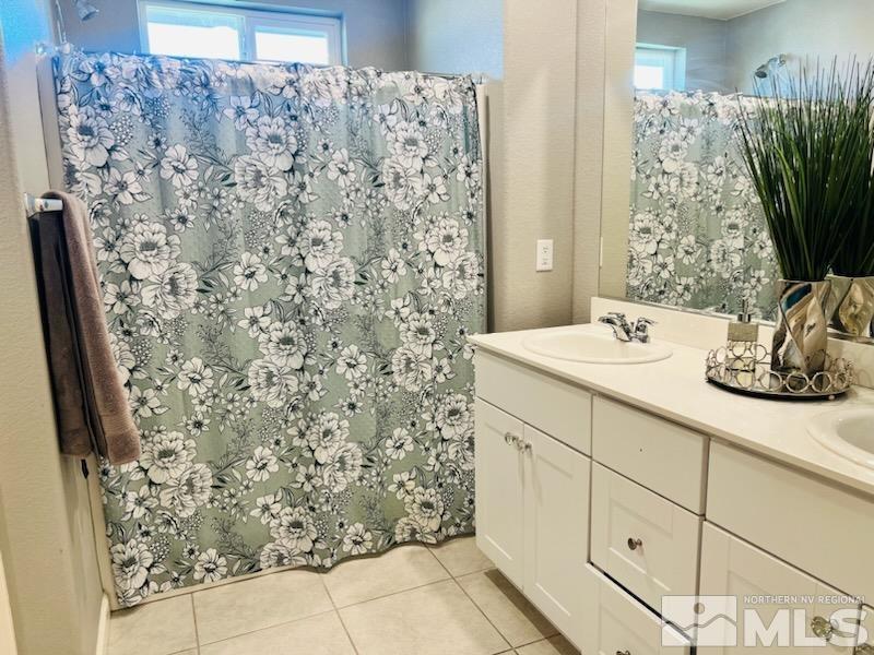8908 Quail Falls Drive Reno, NV 89506 - Photo 10 of 17 a bathroom with a sink and a mirror