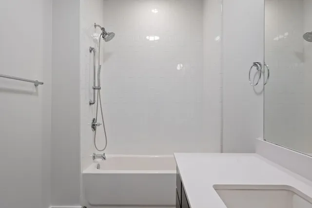 a bathroom with a bathtub and shower