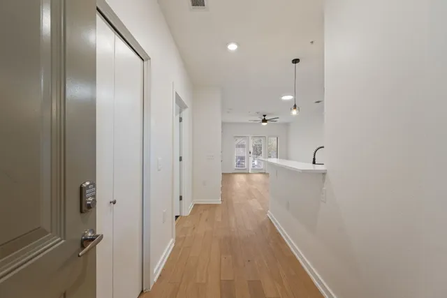 a view of a hallway with wooden floor