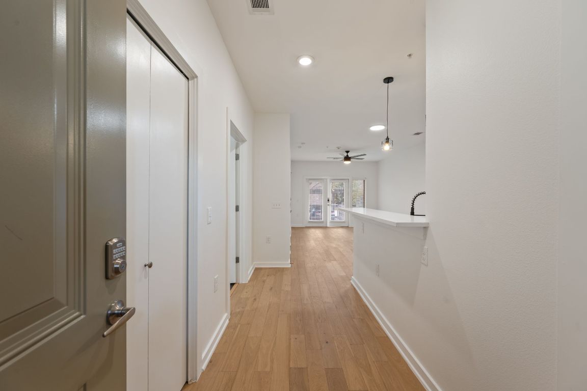 2505 Thornton Road, Unit 3103 Austin, TX 78704 - Photo 2 of 29 a view of a hallway with wooden floor