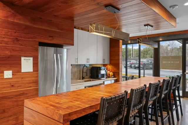 a outdoor kitchen with a table and chairs