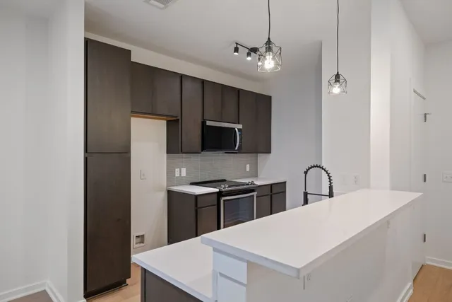 a kitchen with stainless steel appliances a refrigerator and a sink