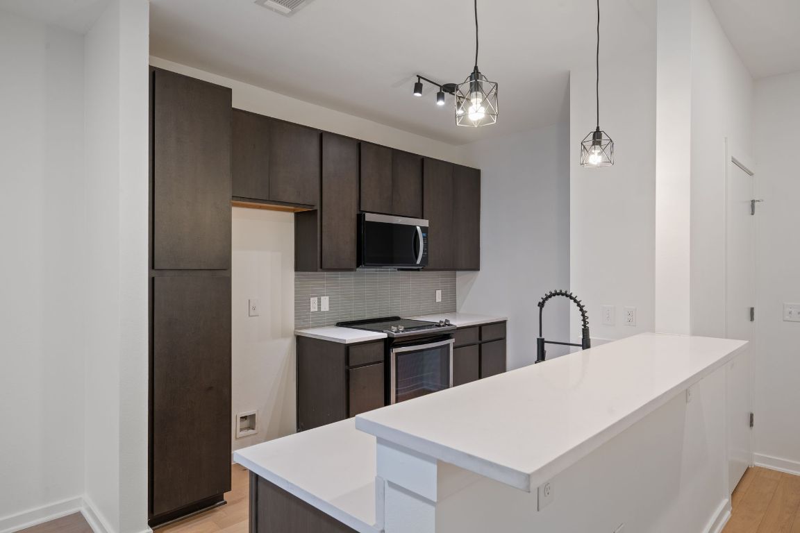 2505 Thornton Road, Unit 3103 Austin, TX 78704 - Photo 3 of 29 a kitchen with stainless steel appliances a refrigerator and a sink