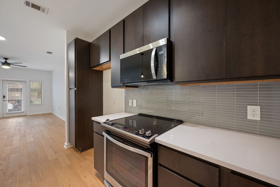 2505 Thornton Road, Unit 3103 Austin, TX 78704 - Photo 5 of 29 a kitchen with a stove and a microwave