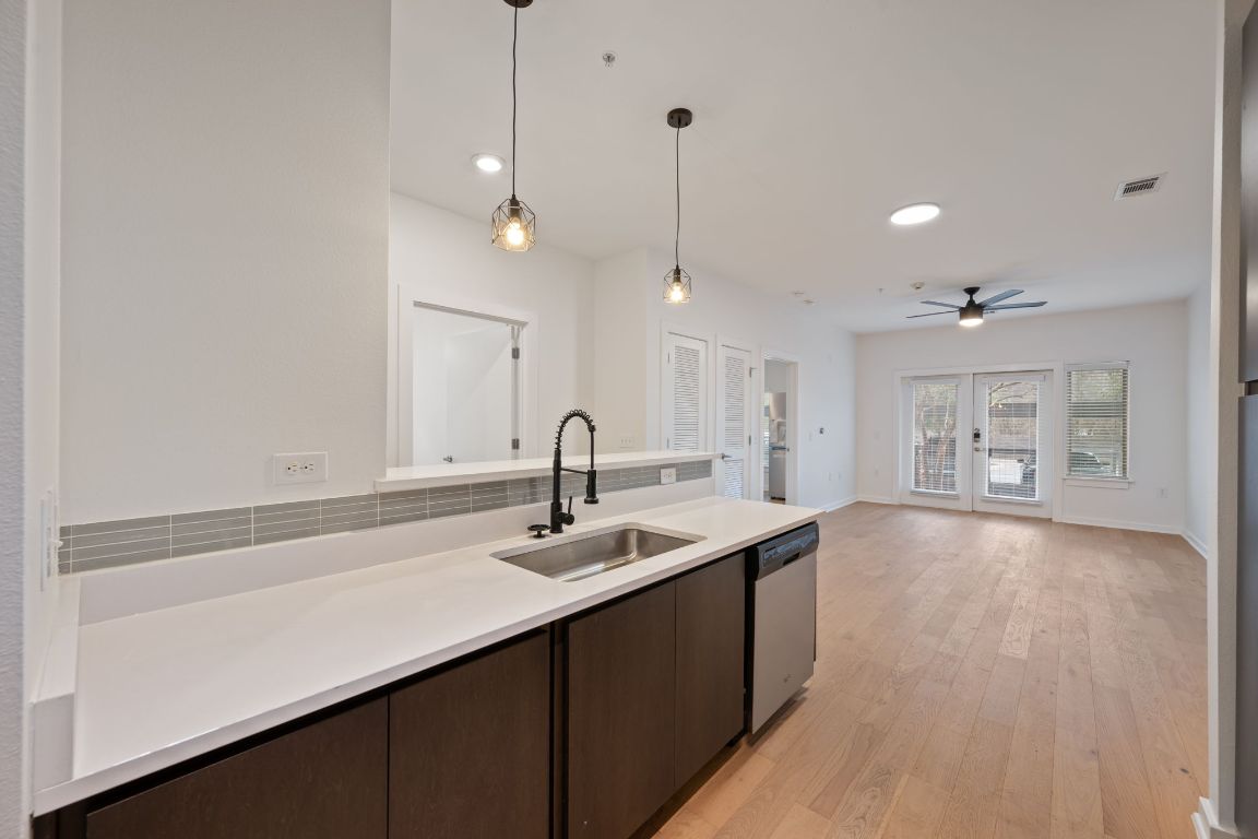 2505 Thornton Road, Unit 3103 Austin, TX 78704 - Photo 6 of 29 a kitchen with stainless steel appliances granite countertop a sink a oven and a granite counter tops with white cabinets