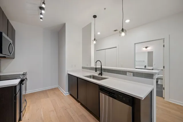 a kitchen with a sink a counter space and cabinets