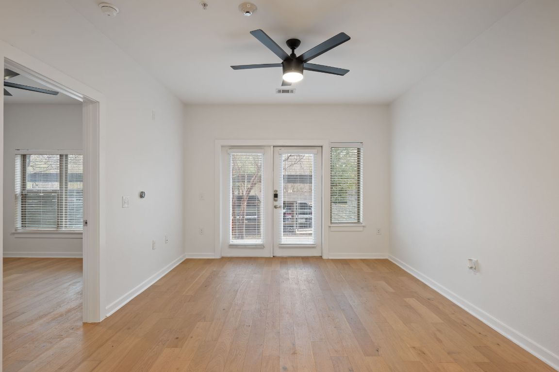 2505 Thornton Road, Unit 3103 Austin, TX 78704 - Photo 10 of 29 an empty room with wooden floor and windows