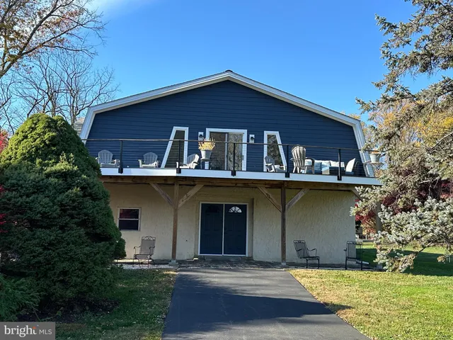 a car parked in front of a house with a yard