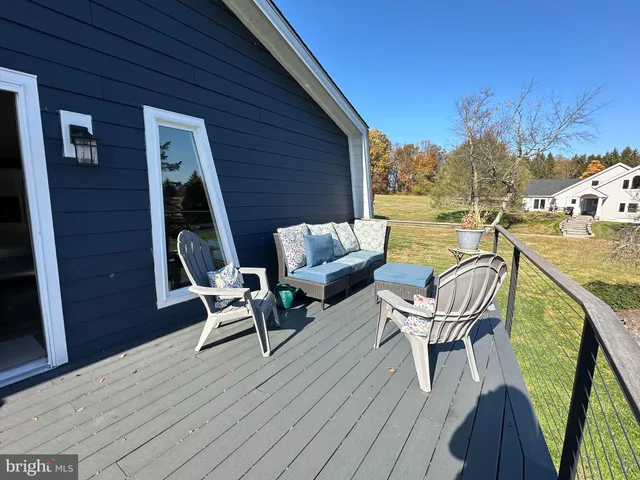 a view of backyard with a deck and wooden floor
