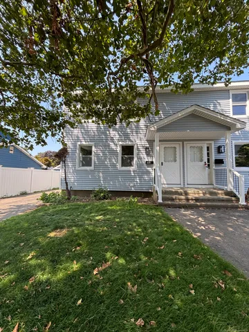 a front view of a house with a garden