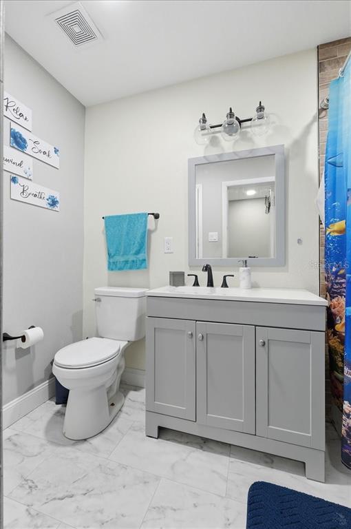 518 West Lake Wales Road North Lake Wales, FL 33859 - Photo 16 of 28 a bathroom with a toilet sink and mirror