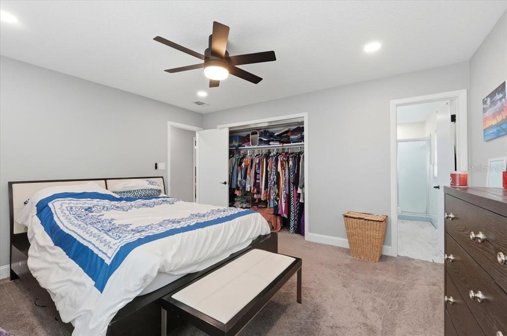 518 West Lake Wales Road North Lake Wales, FL 33859 - Photo 18 of 28 a bedroom with a bed and a chandelier