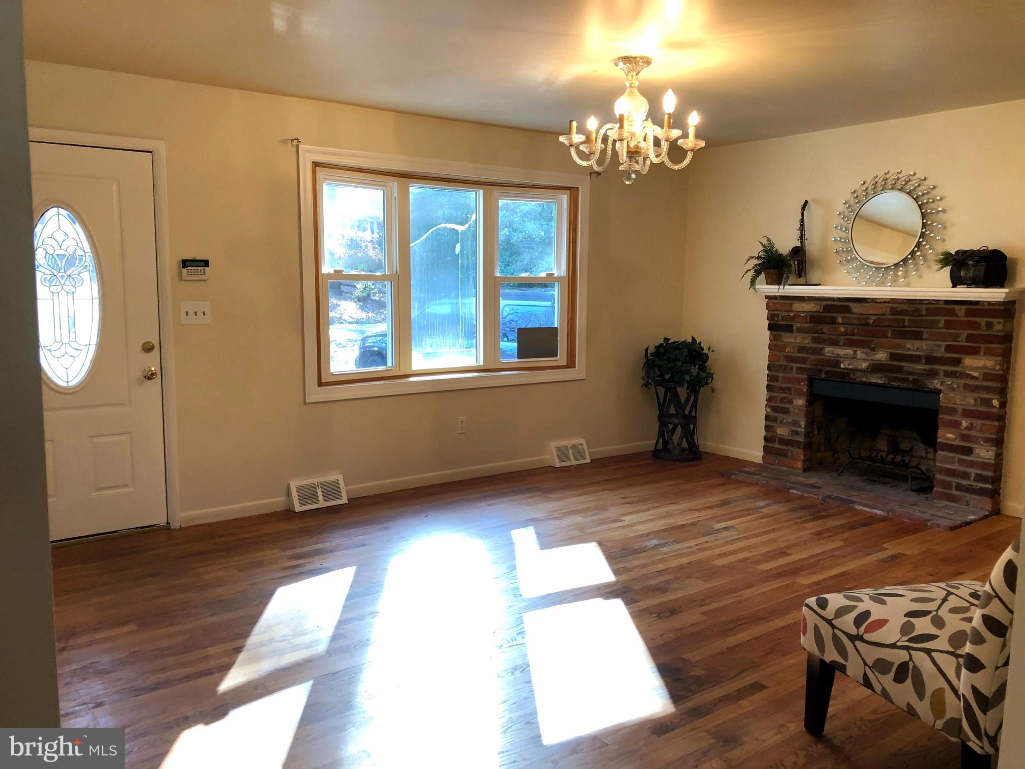 1628 Colony Road Pasadena, MD 21122 - Photo 2 of 29 Sunny Liv Rm w/FP & Hardwoods floors