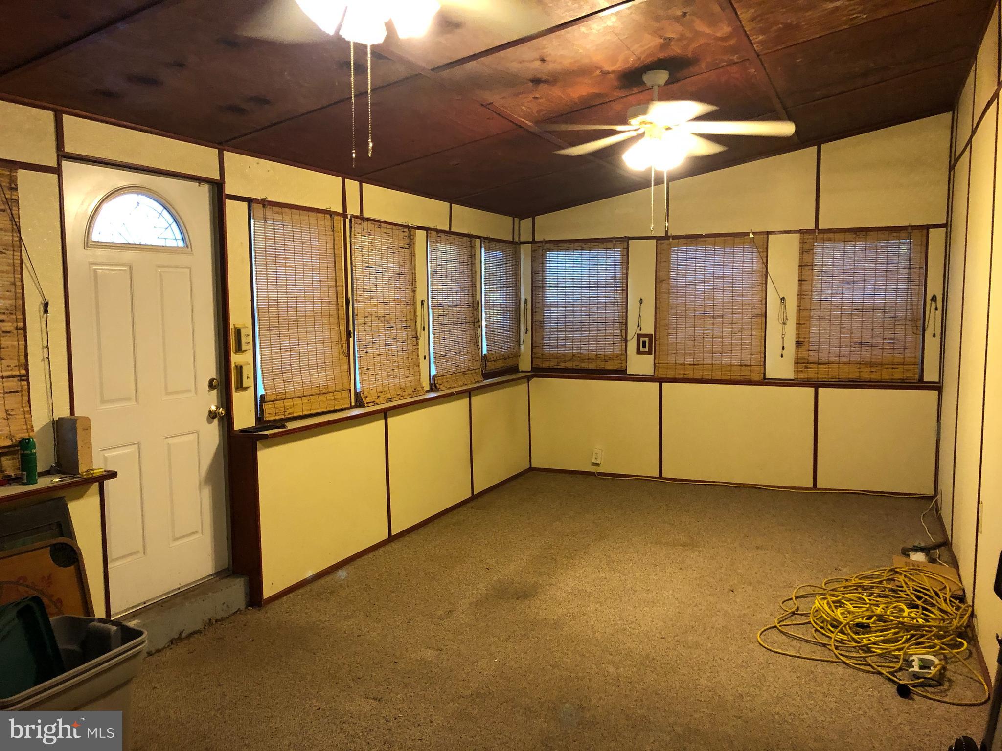 1628 Colony Road Pasadena, MD 21122 - Photo 16 of 29 Enclosed rear, ground-level porch.