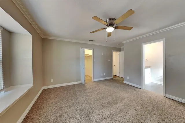 a view of a livingroom with a ceiling fan and window