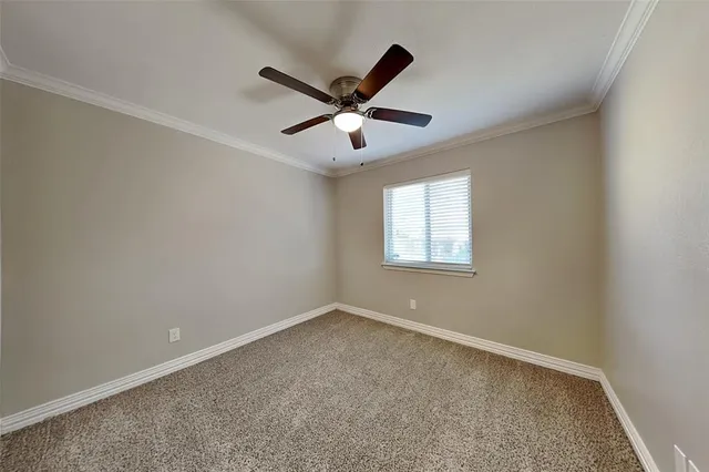 a view of a room with a ceiling fan and a window