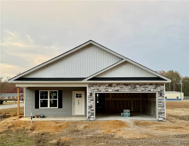 a front view of a house with yard and garage