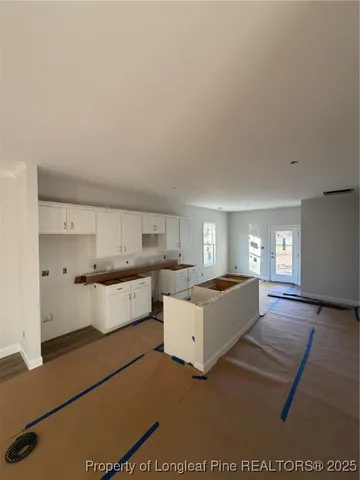 a large kitchen with a large counter top appliances and cabinets