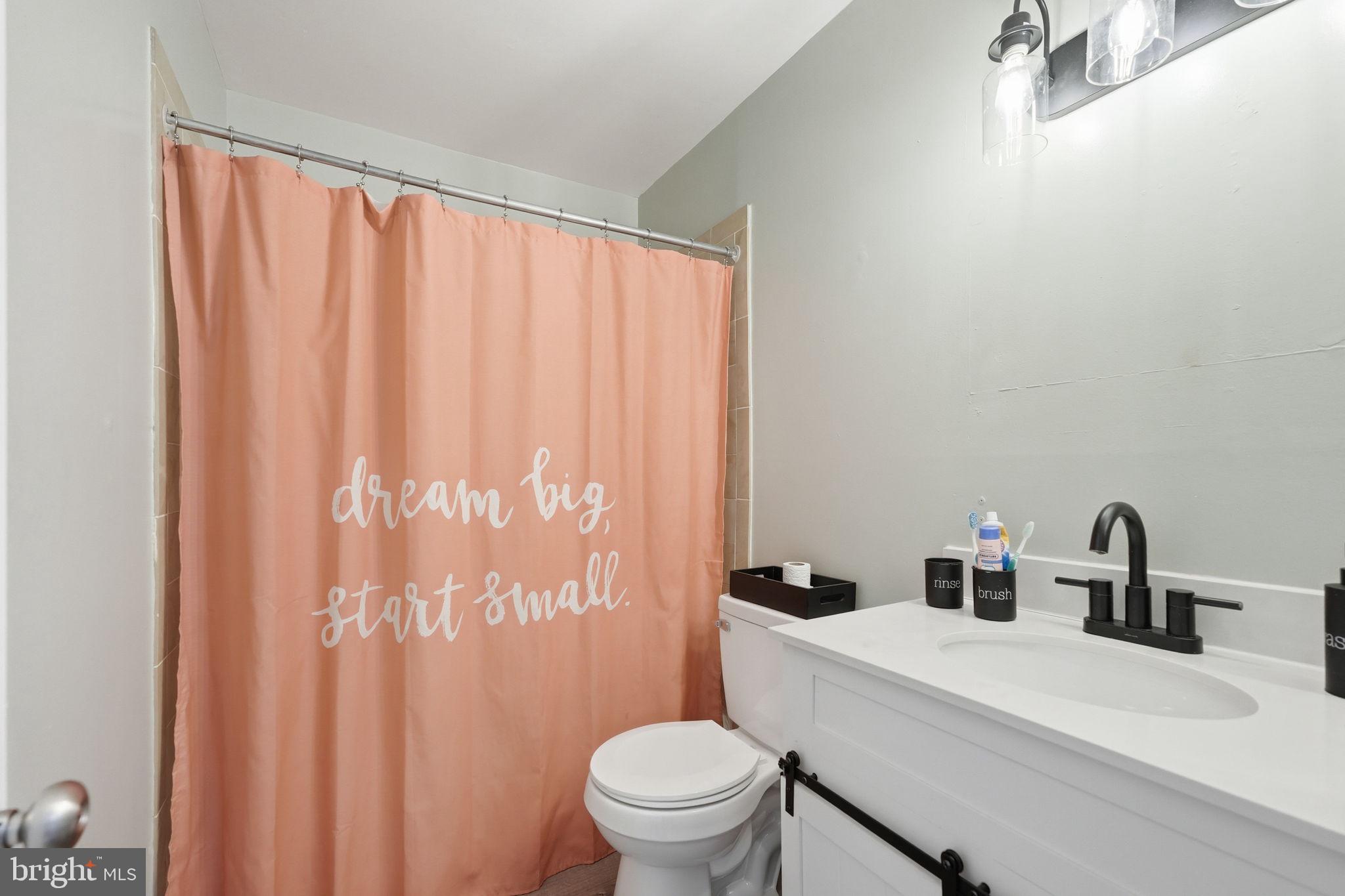 8260 Getty Court Springfield, VA 22153 - Photo 23 of 31 a bathroom with a sink a toilet and a mirror