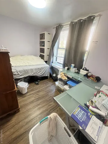 a bedroom with a bed window and a mirror