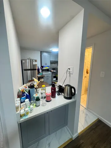 a kitchen with a sink a stove and cabinets