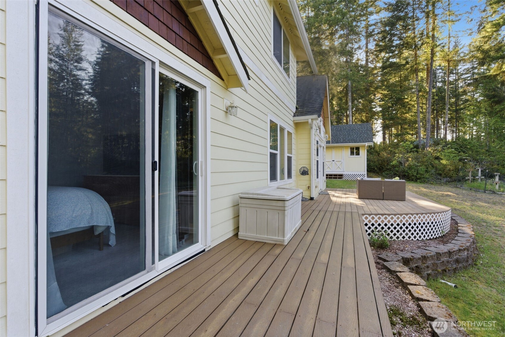6971 Northeast Tahuya Blacksmith Road Belfair, WA 98528 - Photo 22 of 38 a view of a balcony with two chairs and wooden floor