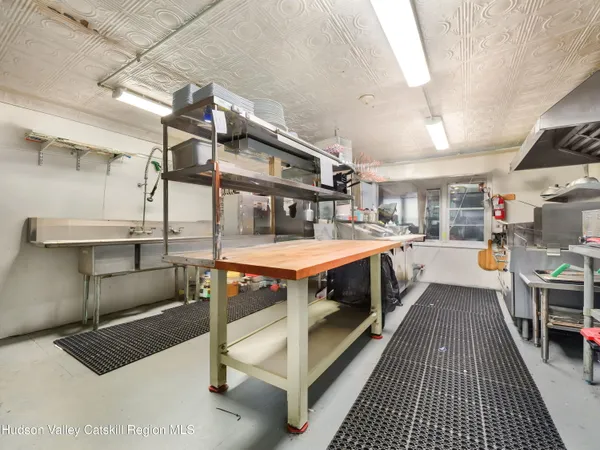 a large kitchen with kitchen island a stove a table and chairs
