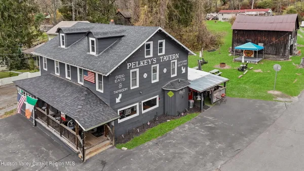 a aerial view of a house with a yard porch and sitting area
