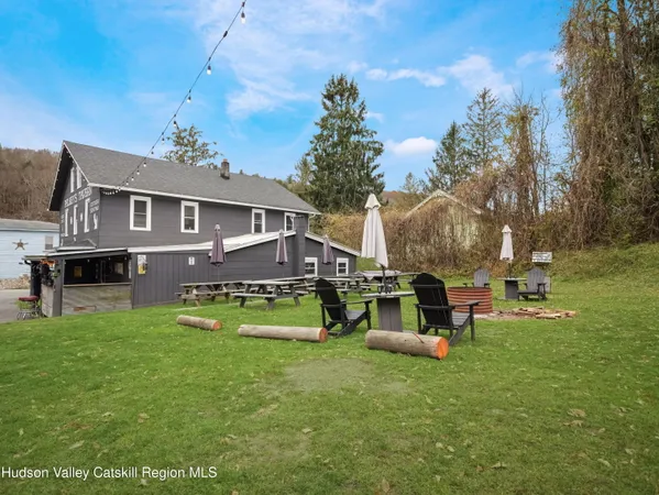 a backyard of a house with table and chairs