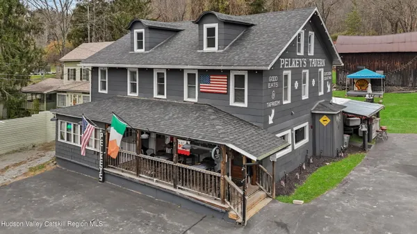 a view of a house with a yard and deck