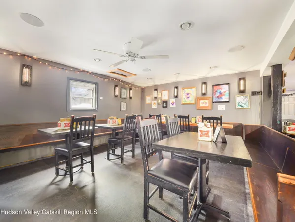 a room with lots of furniture and a view of dining room