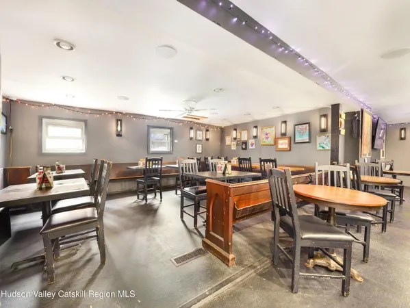 a dining room with furniture and wooden floor