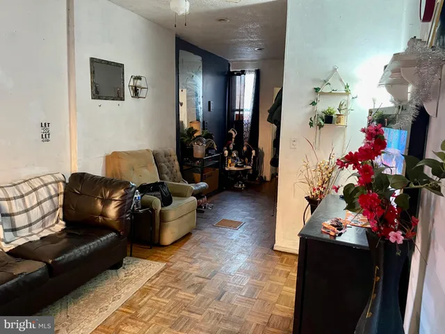 a living room with furniture and flowers