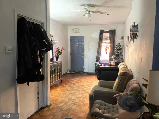 a living room with furniture and a closet