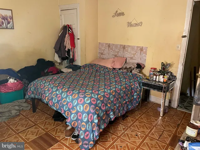 a bedroom with a bed and a dresser