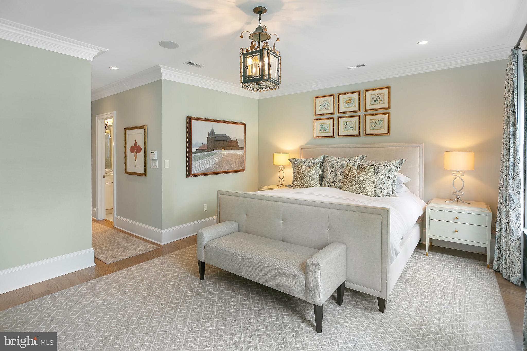 2807 Q Street Northwest Washington, DC 20007 - Photo 18 of 34 a spacious bedroom with a bed and a chandelier