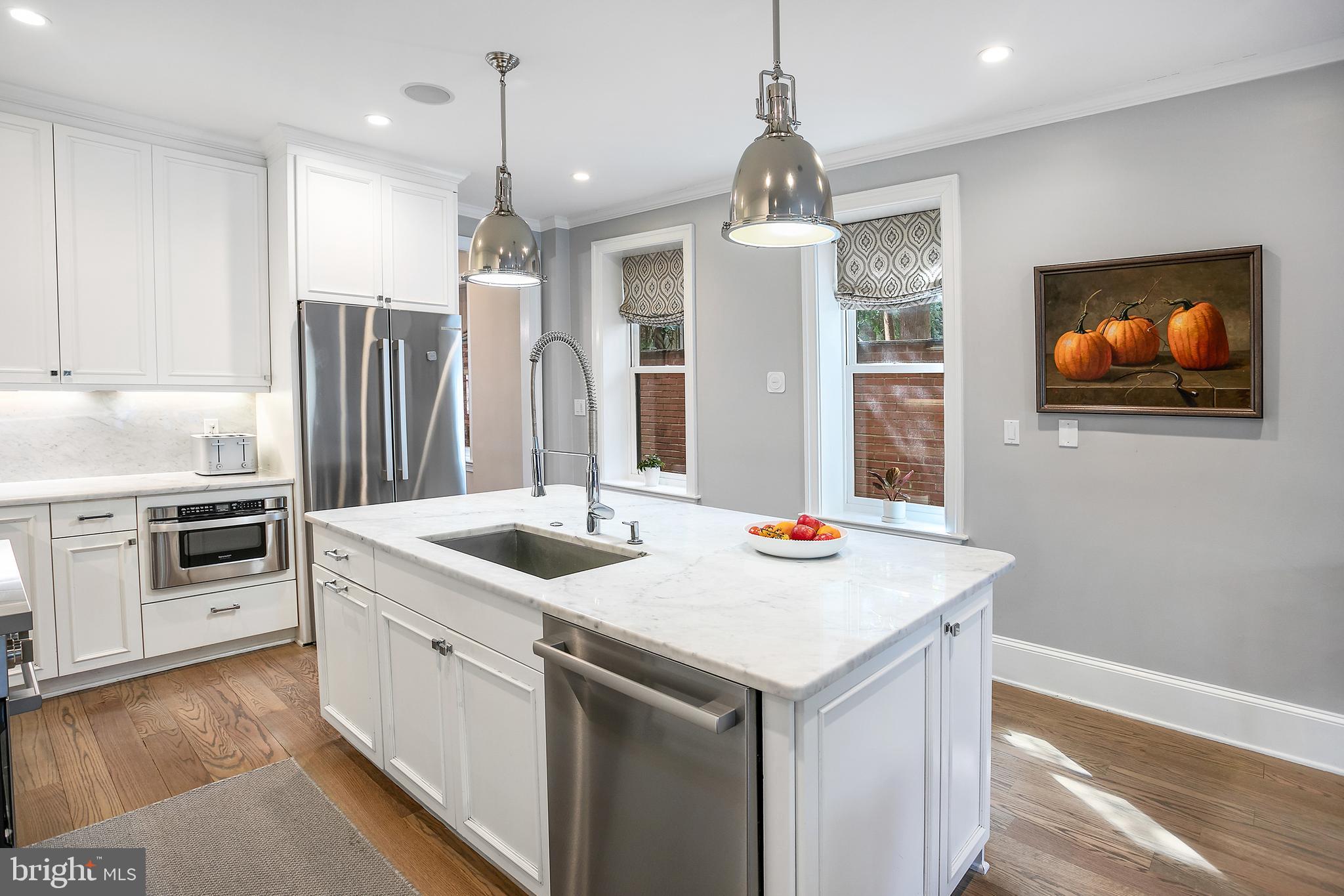 2807 Q Street Northwest Washington, DC 20007 - Photo 9 of 34 a kitchen that has a sink and a stove in it