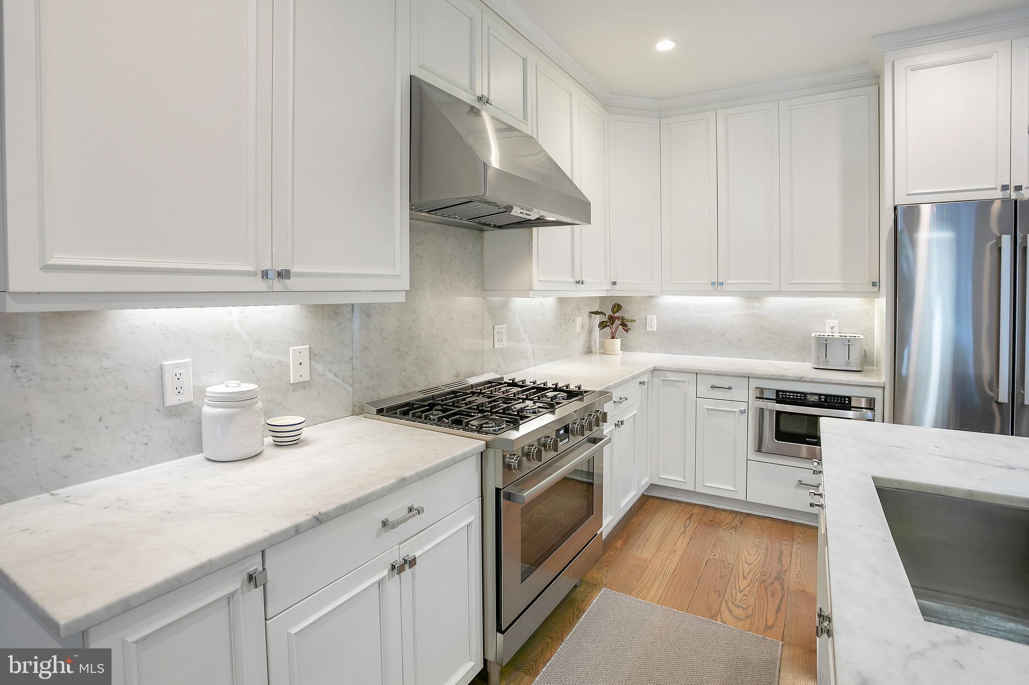 2807 Q Street Northwest Washington, DC 20007 - Photo 10 of 34 a kitchen with a stove a sink and a refrigerator