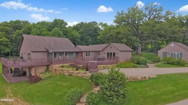 a view of a big house with a big yard and potted plants