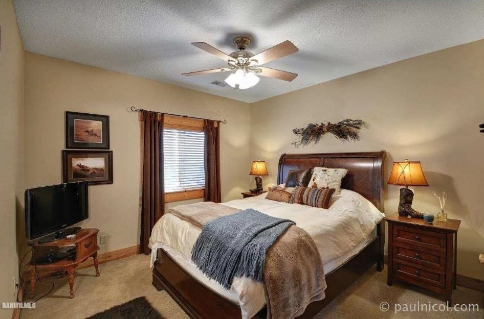 2287 West Hanover Road Hanover, IL 61041 - Photo 17 of 38 a bedroom with a bed and a chandelier