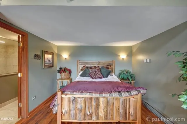 a bed sitting in a bedroom next to a window